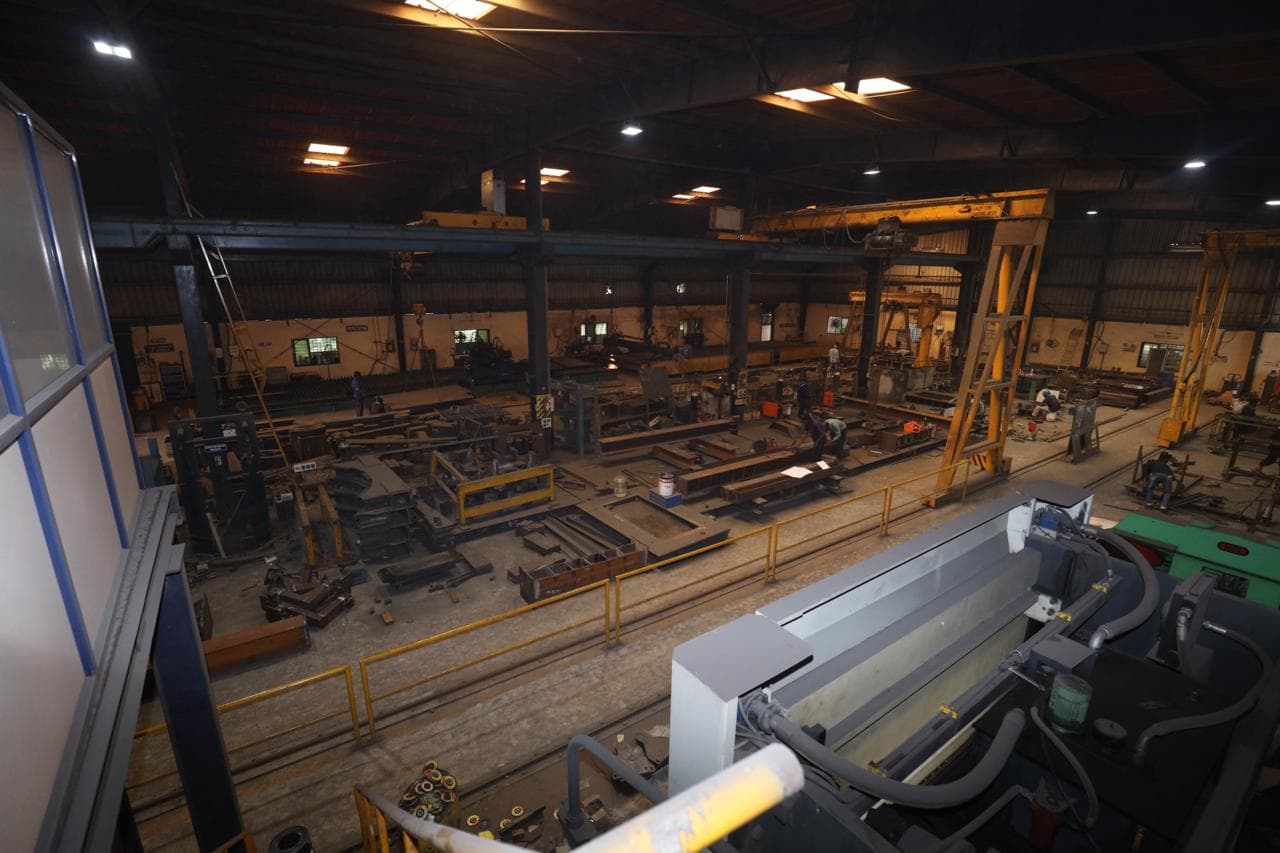 Works gate with fresh plate stock unloaded alongside